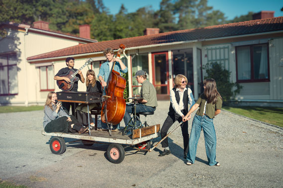 musicians playing outside on a trolley