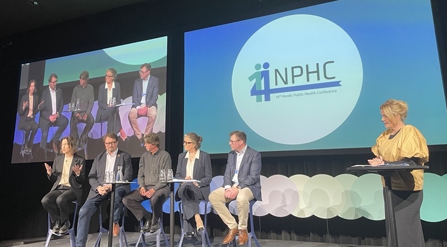 people sitting on a stage talking to the audience
