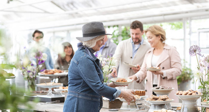 people serving themselves at a buffet